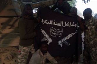 Nigerian army pose with boko haram flag