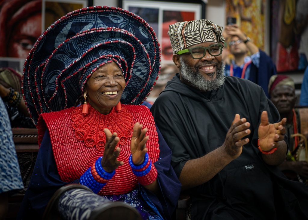 Chief Dr. Nike Davies-Okundaye, left, and Jesse King Buga applaud during a performance by the Maritime Winds of the U.S. Naval Forces Europe-Africa Band at the Nike Art Foundation in Lagos, Nigeria, Jan. 29, 2023, during exercise Obangame Express 2023.