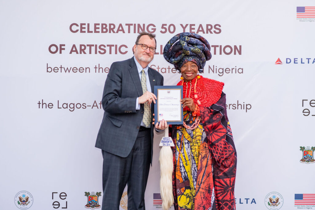 U.S. Ambassador Richard Mills (left); with founder of Nigeria's renowned Nike Art Gallery, Chief Nike Davies-Okundaye, during the U.S. Exchange Alumni Lifetime Achievement Award organized in commemoration of the 50 years of artistic collaborations between the United States and Nigeria and the 50-year Sister Cities partnership between Lagos and Atlanta-olorisupergal