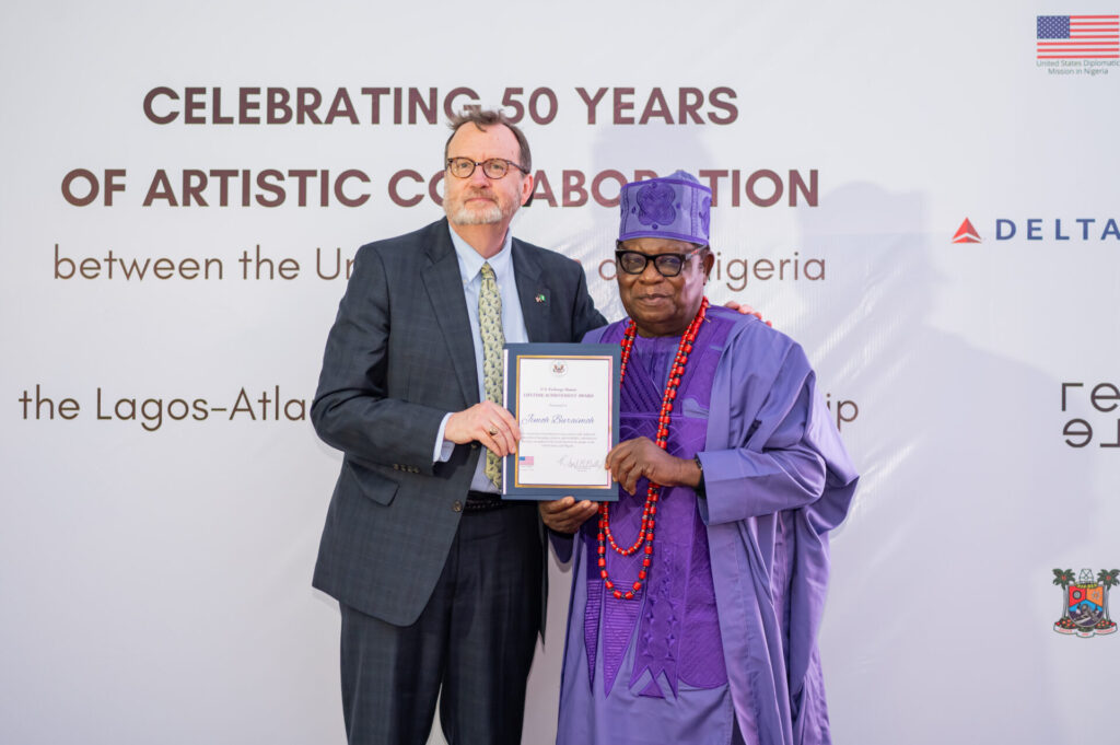 U.S. Ambassador Richard Mills (left); with celebrated bead painter, Chief Jimoh Buraimoh; during the U.S. Exchange Alumni Lifetime Achievement Award organized in commemoration of the 50 years of artistic collaborations between the United States and Nigeria and the 50-year Sister Cities partnership between Lagos and Atlanta.-olorisupergal