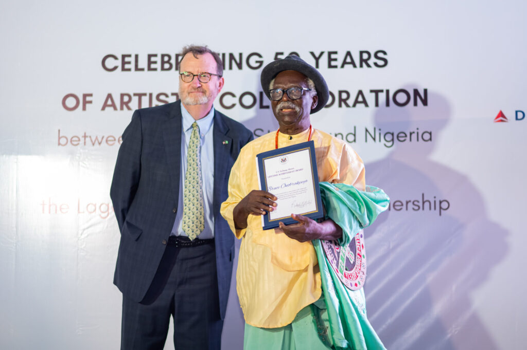 U.S. Ambassador Richard Mills (left); with legendary Nigerian painter and sculptor, Professor Bruce Onobrakpeya; during the U.S. Exchange Alumni Lifetime Achievement Award, organized in commemoration of the 50 years of artistic collaborations between the United States and Nigeria and the 50-year Sister Cities partnership between Lagos and Atlanta.-olorisupergal