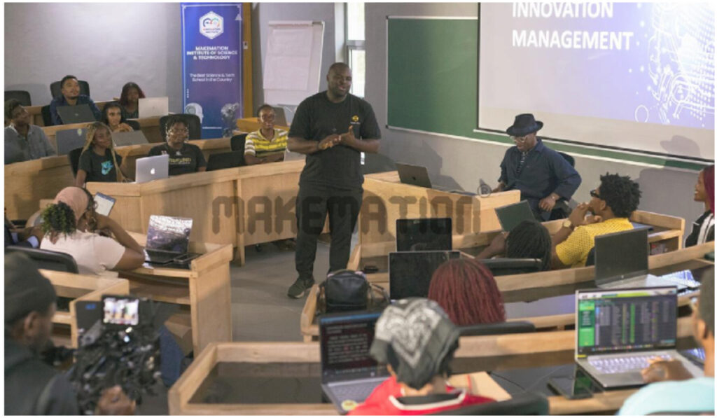 "Iyinoluwa Aboyeji [Tech Founder & Venture Capitalist] and Kunle Sorinyan [Futurist & Thought Leader] in a classroom scene at the Makemation Institute."