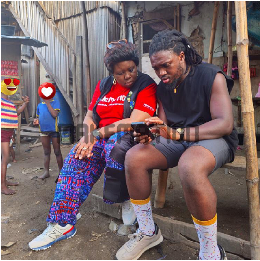 From the left: "Toyosi Akerele-Ogunsiji [Producer/Executive Producer] and Michael 'Ama Psalmist' Akinrogunde [Director] behind the scenes in the Ago-Egun community, Bariga, Lagos.” 