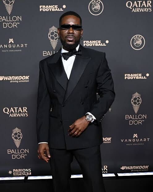 Adekunle Gold wearing a black suit on the red carpet at Ballon d’Or 2025 in Paris- OLORISUPERGAL MEDIA